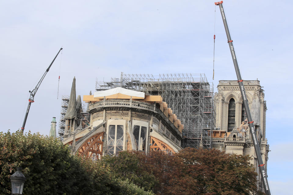 Notre Dame cathedral is pictured Tuesday, Oct. 15, 2019 in Paris. French Culture Minister Franck Riester said the melted, twisted scaffolding atop Notre Dame Cathedral will be removed "in coming weeks" to allow restoration work to begin. It's been six months since fire gutted the medieval structure, which was under renovation at the time and crisscrossed with scaffolding where the spire once stood. (AP Photo/Michel Euler)