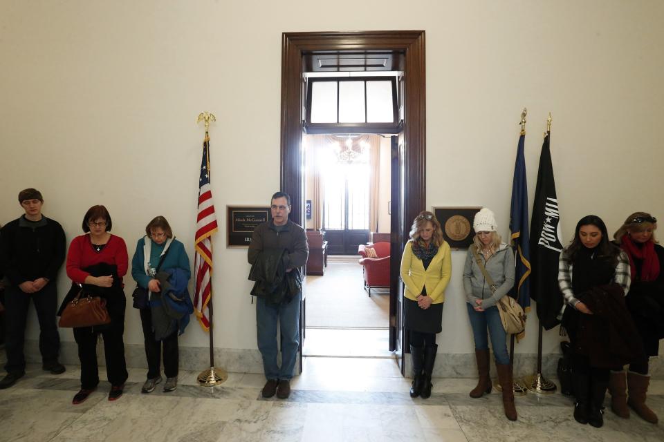 Anti-abortion demonstrators pray in the hallway outside Senate Majority Leader McConnell's legislative office on Capitol Hill in Washington