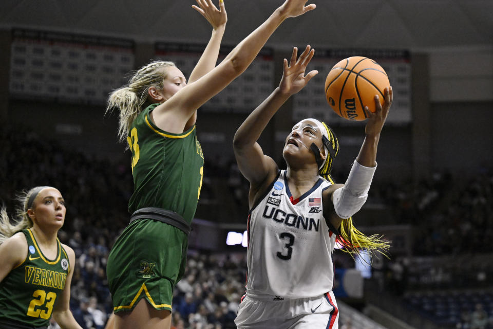 UConn's Aaliyah Edwards (3) goes up for a basket as Vermont's Delaney Richason (33) defends in the second half of a first-round college basketball game in the NCAA Tournament, Saturday, March 18, 2023, in Storrs, Conn. (AP Photo/Jessica Hill)