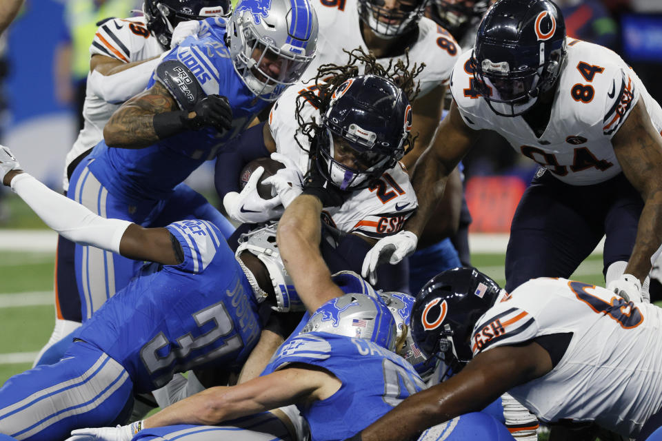 Chicago Bears running back D'Onta Foreman (21) is tackled during the first half of an NFL football game against the Detroit Lions, Sunday, Nov. 19, 2023, in Detroit. (AP Photo/Duane Burleson)