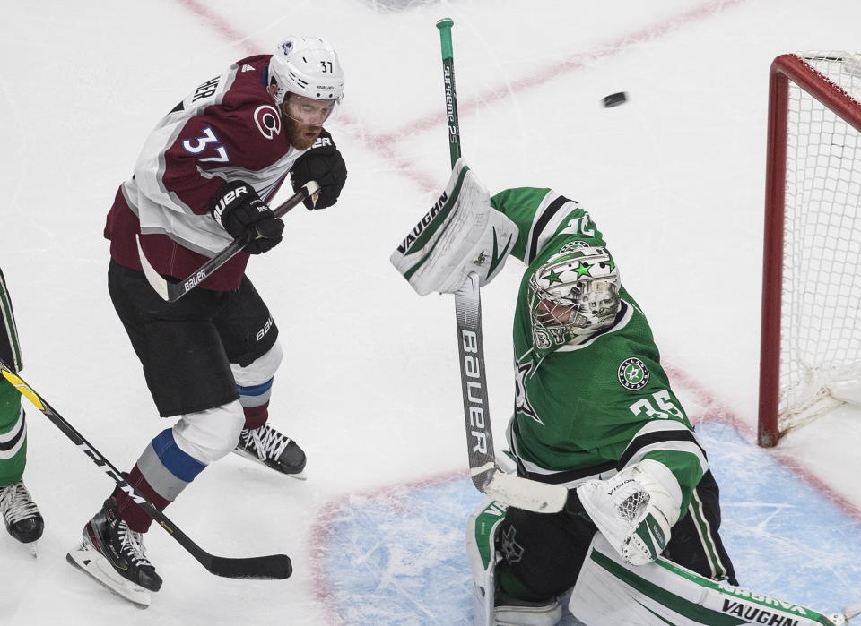 Dallas Stars' goalie Anton Khudobin (35) makes a save as Colorado Avalanche's J.T. Compher (37) screens during the third period of an NHL hockey second-round playoff series, Sunday, Aug. 30, 2020, in Edmonton, Alberta. (Jason Franson/The Canadian Press via AP)