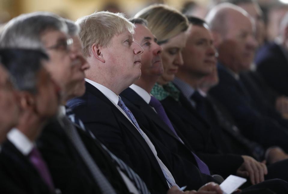 Britain's Foreign Secretary Boris Johnson, center, listens as Prime Minister Theresa May delivers a speech on leaving the European Union at Lancaster House in London, Tuesday, Jan. 17, 2017. (AP Photo/Kirsty Wigglesworth, pool)