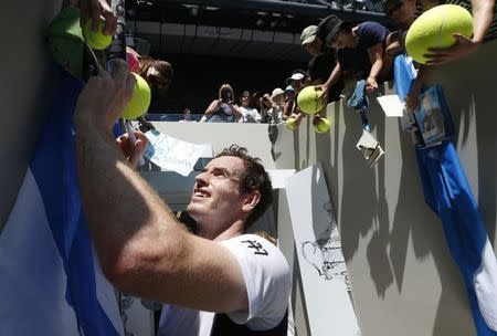 Britain's Andy Murray signs autographs after winning his first round match against Germany's Alexander Zverev at the Australian Open tennis tournament at Melbourne Park, Australia, January 19, 2016. REUTERS/Jason Reed