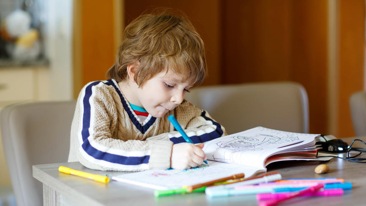 Child With Coloring Books and Markers