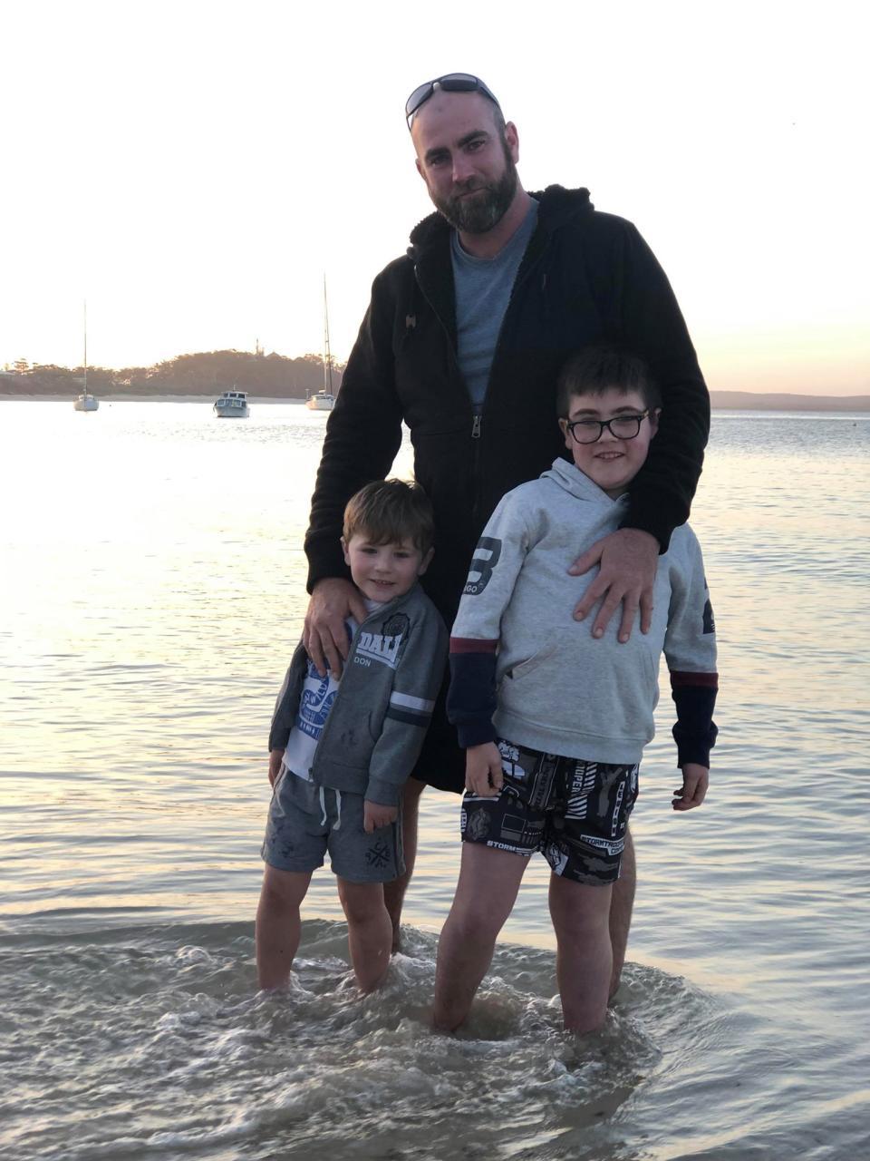 Pictured is father Nathan Brown with his two sons, Tarek and Riley, in the water.