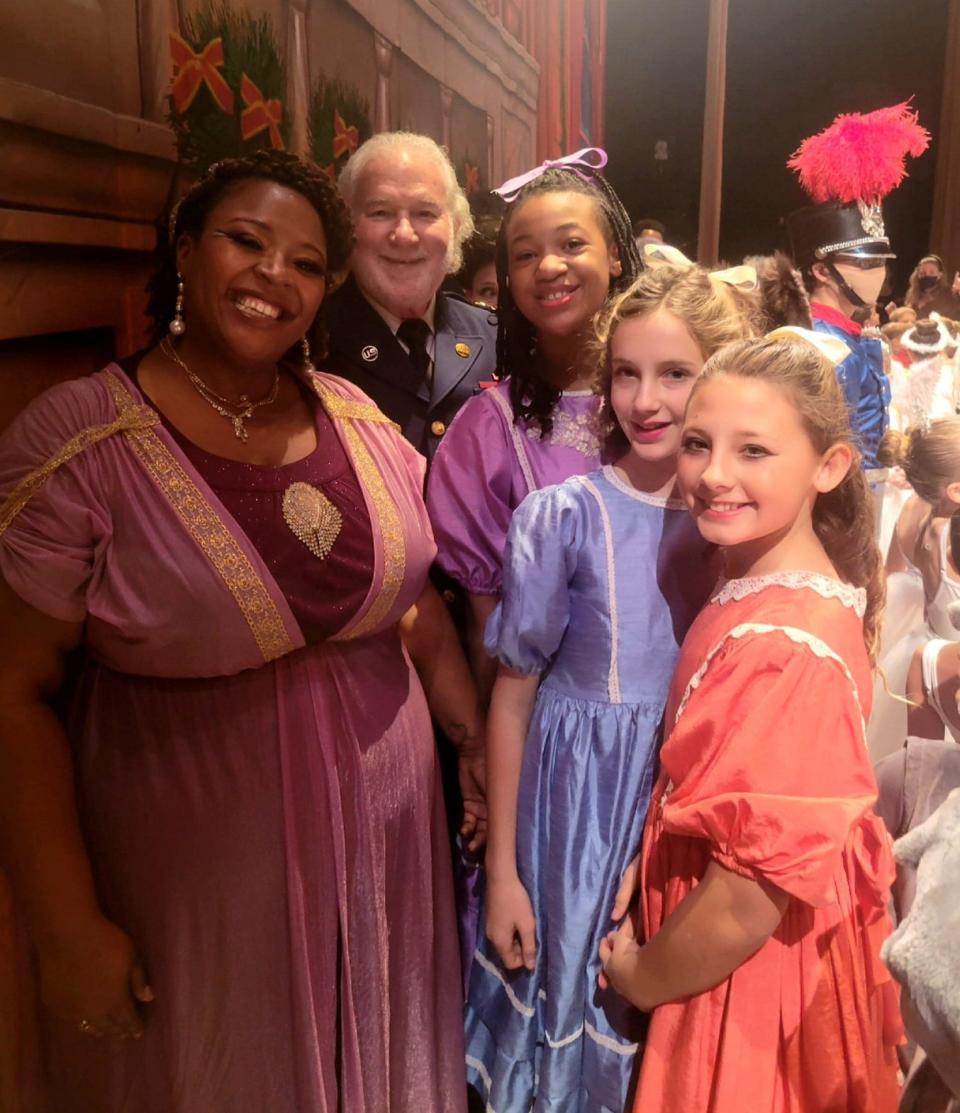 Sarah Taylor, left, executive director of Southold Dance Theater in South Bend, poses with other cast members of a recent year's production of "The Nutcracker." Taylor played the role of a party parent.