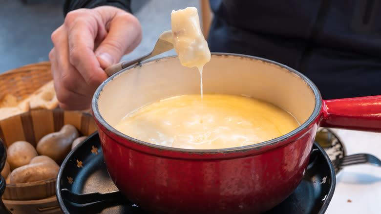 fondue pot with melted cheese