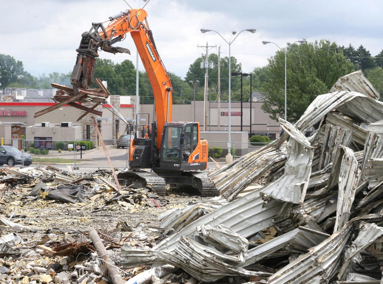 The former Kmart building in North Canton is torn down on Tuesday.