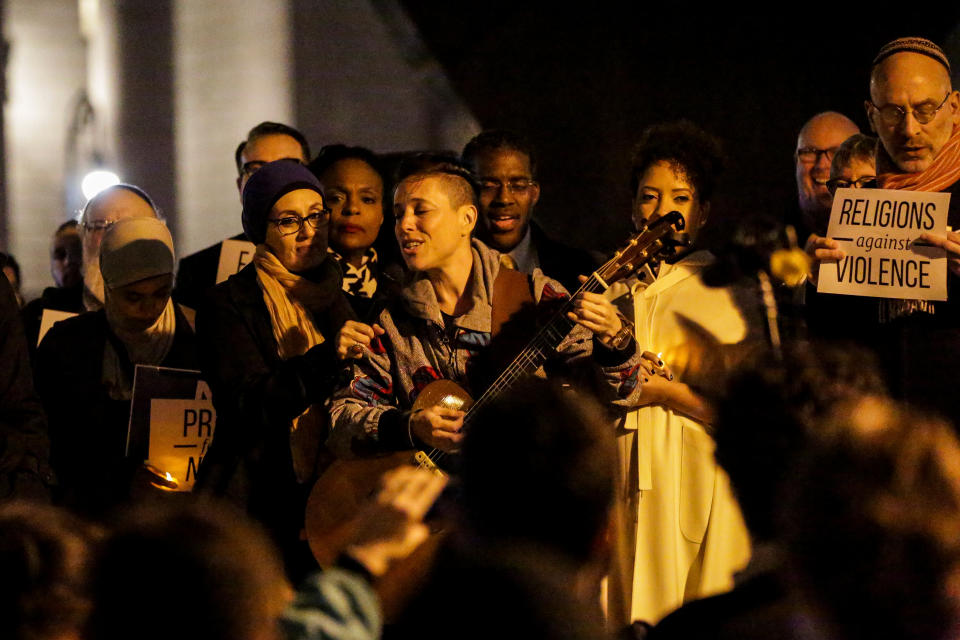 <p>A woman sings during a candlelight vigil for victims of the pickup truck attack at Foley Square in New York City, Nov. 1, 2017. (Photo: Jeenah Moon/Reuters) </p>