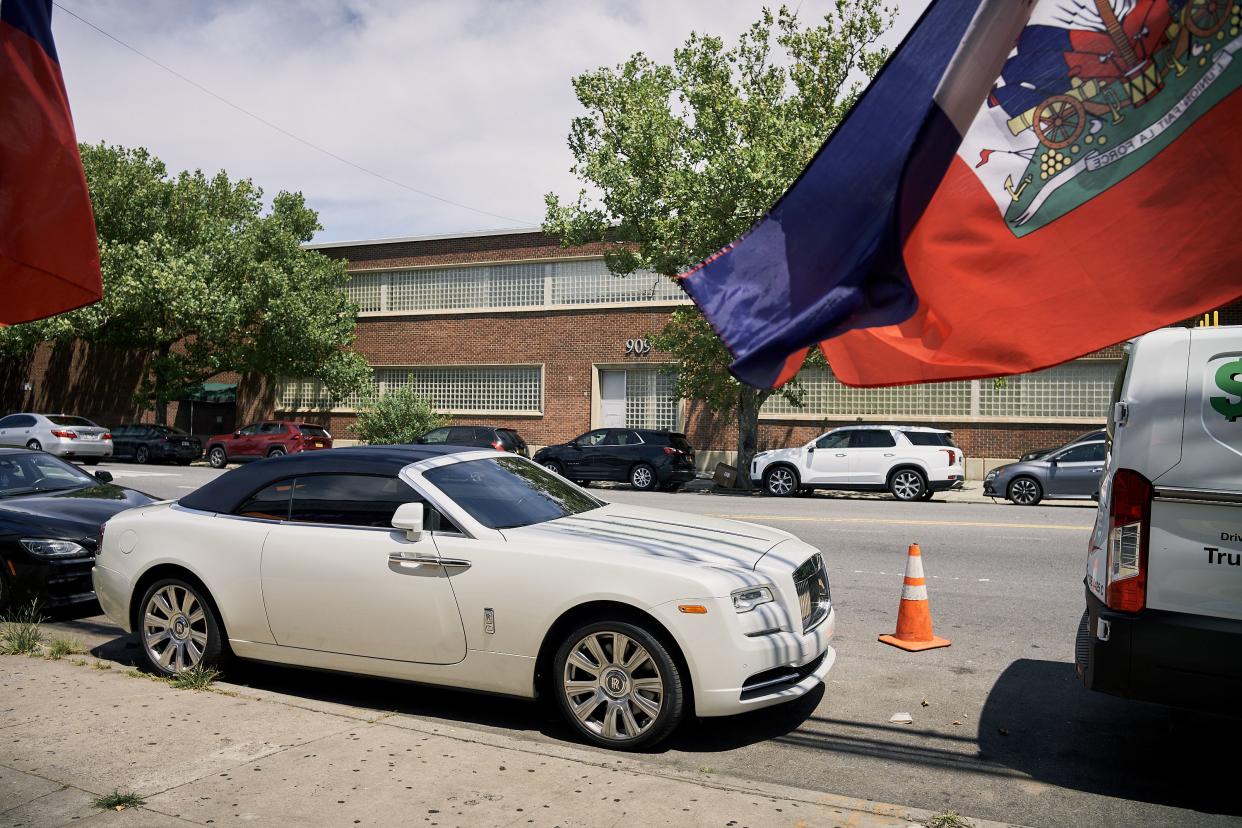 Whitehead’s white Rolls-Royce convertible outside of his church.