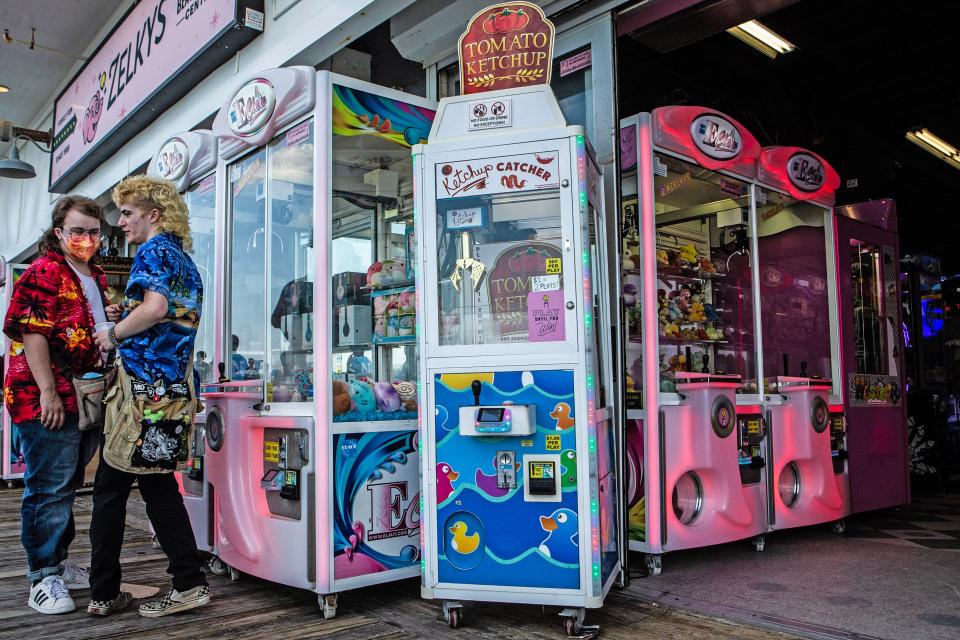 The Tomato Ketchup claw machine full of ketchup packages is featured at Zelky's Beach Arcade on the boardwalk at Rehoboth Beach on Tuesday, June 13, 2023. For 50 cents, people can "play the ketchup game" and get packages for their fries.