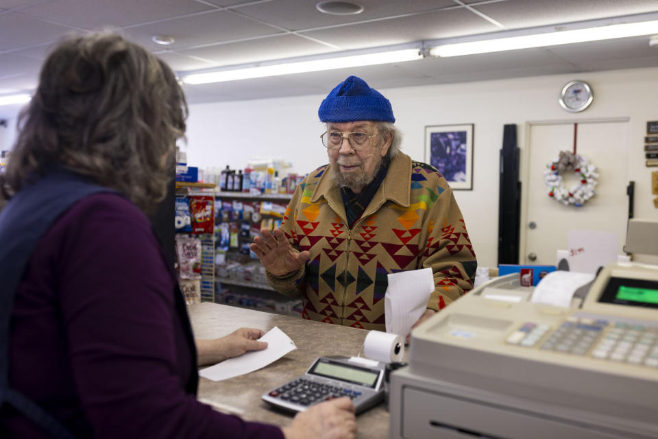 Joseph Yearicks talks to Marla Winters after picking up a prescription at Basin Pharmacy in Basin, Wyo., on Wednesday, Feb. 21, 2024. (AP Photo/Mike Clark)