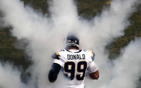 Los Angeles Rams' Aaron Donald runs onto the field before an NFL football game against the Los Angeles Chargers - Credit: (AP Photo/Jae C. Hong)