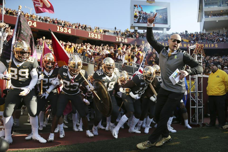 Minnesota head coach P.J. Fleck leads him team on the field prior to an NCAA college football game against Maryland, Saturday, Oct. 26, 2019, in Minneapolis. Minnesota won 52-10. (AP Photo/Stacy Bengs)