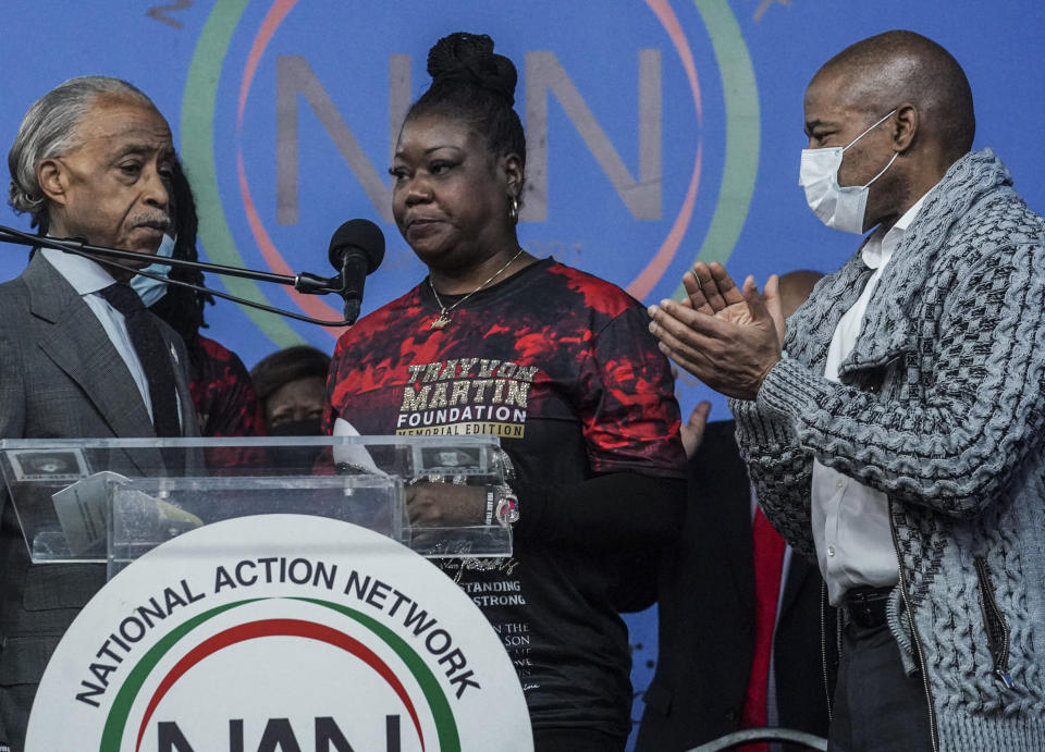 Rev. Al Sharpton, left, president of the National Action Network (NAN), and Mayor Eric Adams, right, stand next to Sybrina Fulton, center, the mother of Trayvon Martin, as she address a rally commemorating the 10th anniversary of her son's killing, Saturday Feb. 26, 2022, at NAN's Harlem headquarters in New York. "Today is a bittersweet day," said Fulton, who with her family created the Trayvon Martin Foundation to raise awareness of gun violence. (AP Photo/Bebeto Matthews)