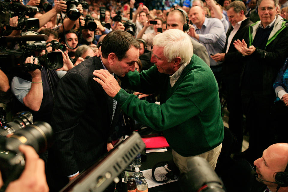 Coach K hugs Bob Knight after breaking his wins record. (Patrick McDermott/Getty Images)