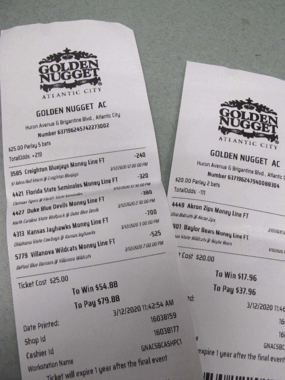 This March 12, 2020 shows a sports betting ticket at the Golden Nugget casino in Atlantic City, N.J. where all five games that were bet on were canceled due to coronavirus precautions. Most professional and college sports events in the U.S. have been suspended or delayed, leaving little to bet on. For most people, the new coronavirus causes only mild or moderate symptoms. For some it can cause more severe illness. (AP Photo/Wayne Parry)