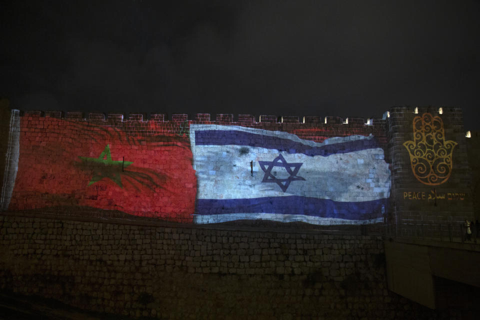 FILE - In this Dec. 23, 2020 file photo, the national flags of Israel and Morocco are projected on the walls of the Old City of Jerusalem, along with the word "peace," in English, Hebrew, and Arabic. Two Israeli airlines launched their first commercial flights between Israel and Morocco on Sunday, July 25, 2021, less than a year after the countries officially normalized relations. (AP Photo/Maya Alleruzzo, File)