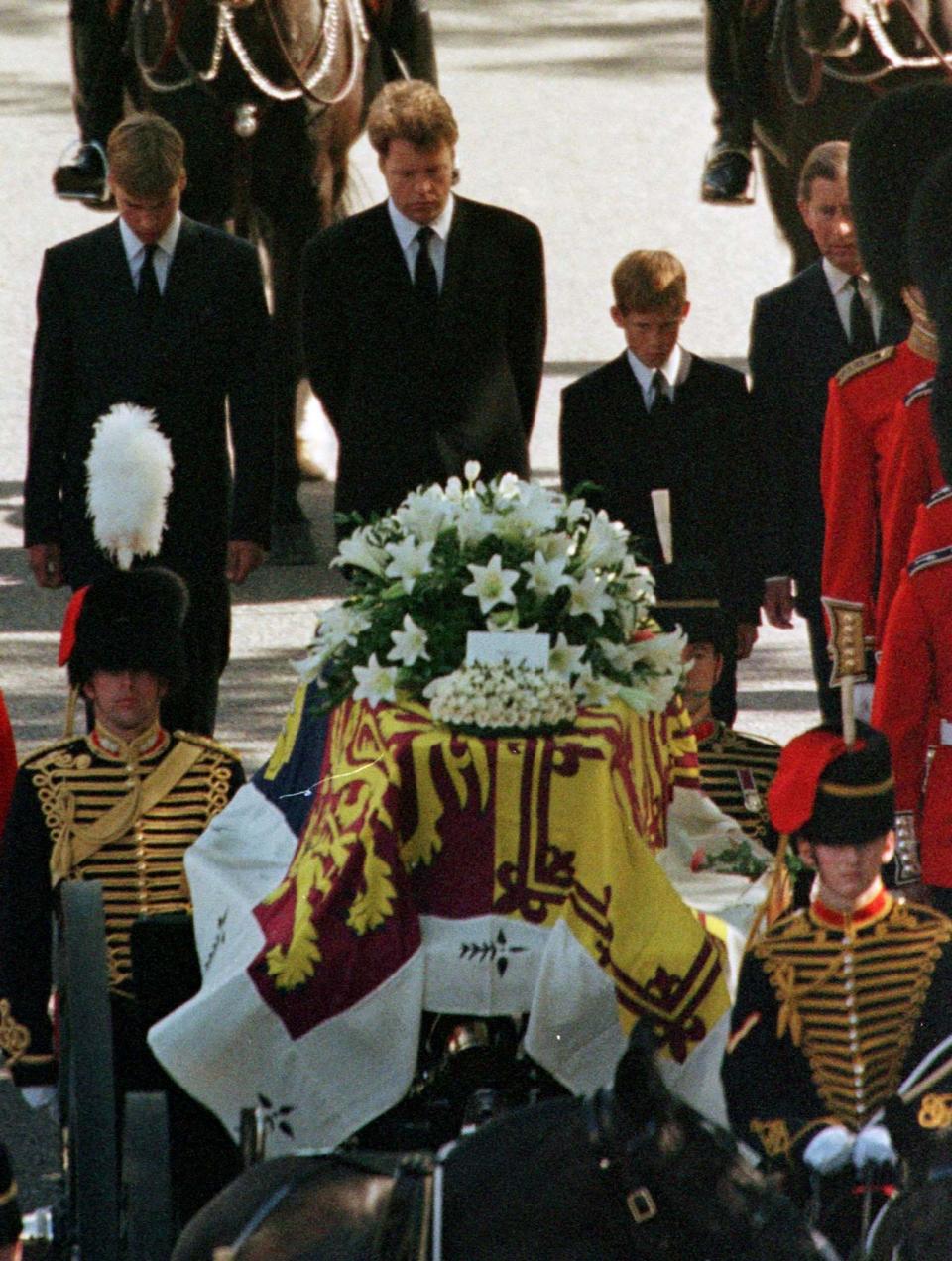 Prince William (L), Earl Spencer (2nd R) , Prince Harry and Prince Charles (partly obscured) follow the coffin of Diana, Princess of Wales September 6 as the funeral cortege arrives at Westminster Abbey September 6. Millions of mourners lined the route to pay their respects.

DIANA