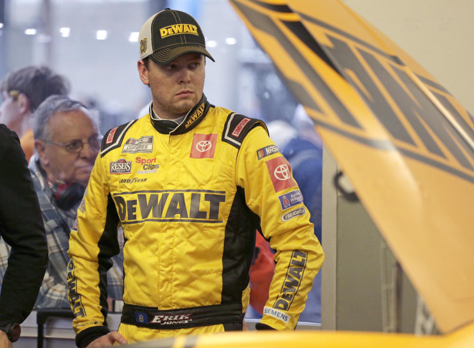 FILE - In this Feb. 14, 2020, file photo, Erik Jones waits by his car as his crew makes adjustments during a practice session for the NASCAR Daytona 500 auto race at Daytona International Speedway in Daytona Beach, Fla. Joey Logano was sitting in his motorhome watching television when a shell-shocked Erik Jones was interviewed about his firing from Joe Gibbs Racing. Logano knew exactly how Jones felt. Logano had been in that exact spot eight years earlier. (AP Photo/Terry Renna, File)