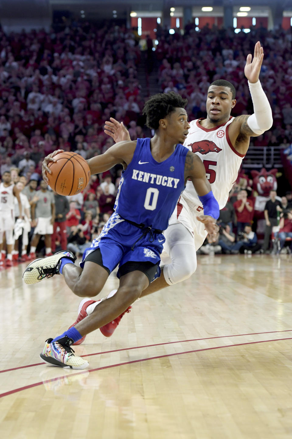 Kentucky guard Ashton Hagans (0) drives past Arkansas defender Reggie Chaney (35) during the second half of an NCAA college basketball game, Saturday, Jan. 18, 2020, in Fayetteville, Ark. (AP Photo/Michael Woods)