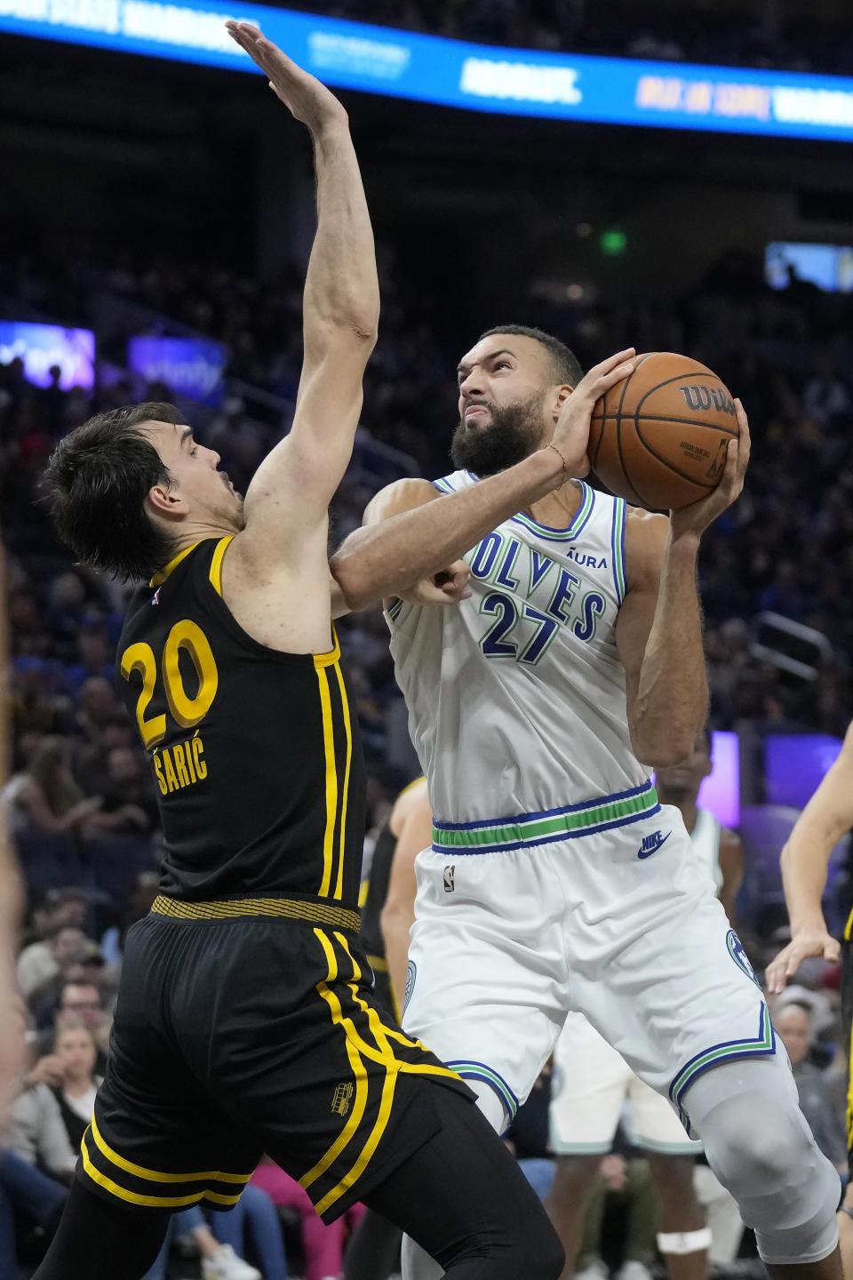 Minnesota Timberwolves center Rudy Gobert (27) shoots against Golden State Warriors forward Dario Saric (20) during the first half of an NBA basketball game in San Francisco, Sunday, Nov. 12, 2023. (AP Photo/Jeff Chiu)