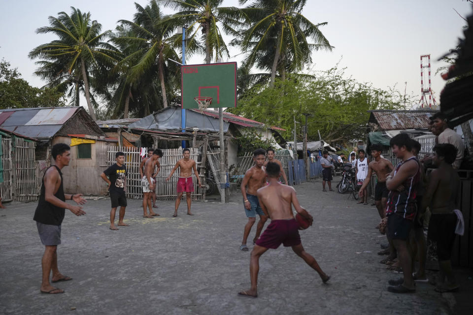 Residents play basketball in a coastal village Tuesday, Aug. 8, 2023, in Batangas province, Philippines. Legend says that American teachers brought basketball to the Philippines for the first time around the turn of the 20th century, and it immediately took off. Basketball’s World Cup starts on Friday, Aug. 25, spread out over three nations. The Philippines, Japan and Indonesia all will be hosts. It’ll be centered in Manila. (AP Photo/Aaron Favila)