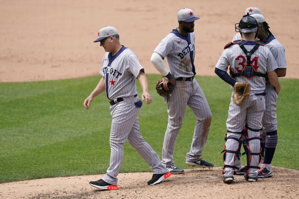 Detroit Tigers manager A.J. Hinch, left, walks back to the dugout after making a pitching change during the seventh inning of a baseball game against the Kansas City Royals Sunday, May 23, 2021, in Kansas City, Mo. (AP Photo/Charlie Riedel)