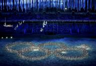 Performers form the Olympic rings during a show at the closing ceremony for the Sochi 2014 Winter Olympics February 23, 2014. REUTERS/Eric Gaillard (RUSSIA - Tags: OLYMPICS SPORT TPX IMAGES OF THE DAY) ATTENTION EDITORS: PICTURE 01 OF 31 FOR PACKAGE 'SOCHI - EDITOR'S CHOICE'. SEARCH 'EDITOR'S CHOICE - 23 FEBRUARY 2014' FOR ALL PICTURES PXP01-PXP31