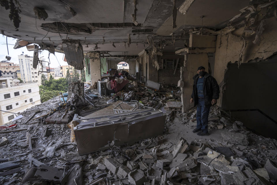 A Palestinian man inspects damage to his building following Israeli airstrikes on an apartment of an Islamic Jihad commander in Gaza City, Tuesday, May 9, 2023. The Israeli military says it has killed three senior commanders of the militant Islamic Jihad group in targeted airstrikes. Palestinian health officials said 13 people were killed in total in Tuesday's attacks, including the commanders, their wives, several of their children and others nearby. (AP Photo/Fatima Shbair)