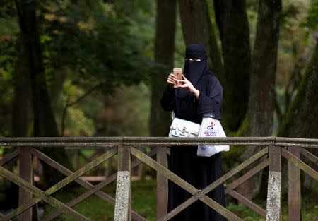 A tourist from the Middle East takes pictures at Vrelo Bosne nature park in Ilidza near Sarajevo, Bosnia and Herzegovina, August 19, 2016. REUTERS/Dado Ruvic