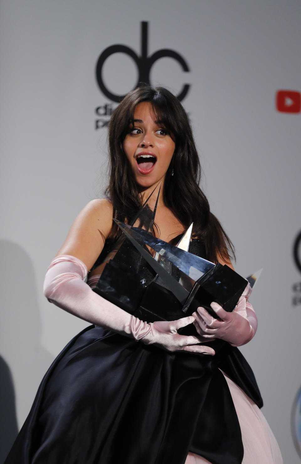 2018 American Music Awards - Photo Room - Los Angeles, California, U.S., 09/10/2018 - Camila Cabello poses backstage with her awards. REUTERS/Mike Blake