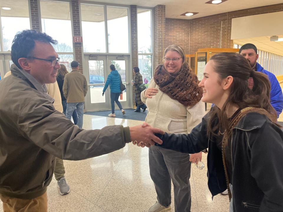 Copley High School junior Adrian Rehill, 17, right, receives congratulatory comments in the high school's atrium following a speech to the school board about being transgender.