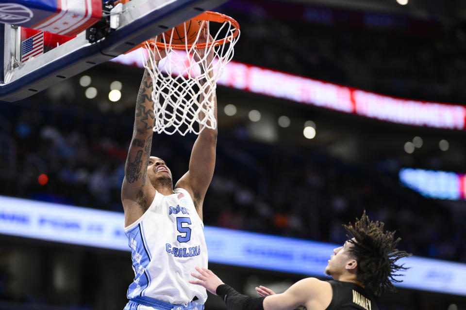 North Carolina forward Armando Bacot dunks over Florida State guard Jalen Warley during the second half of an NCAA college basketball game in the quarterfinal round of the Atlantic Coast Conference tournament, Thursday, March 14, 2024, in Washington. (AP Photo/Nick Wass)