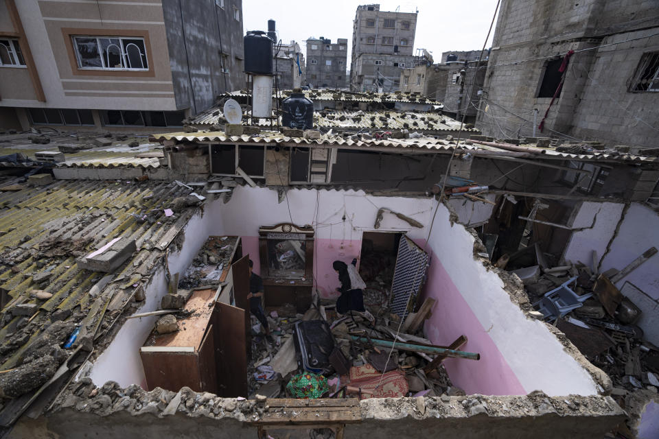 Palestinians inspect the damage to a house after an Israeli airstrike in Rafah, southern Gaza Strip, Tuesday, March 19, 2024. (AP Photo/Fatima Shbair)