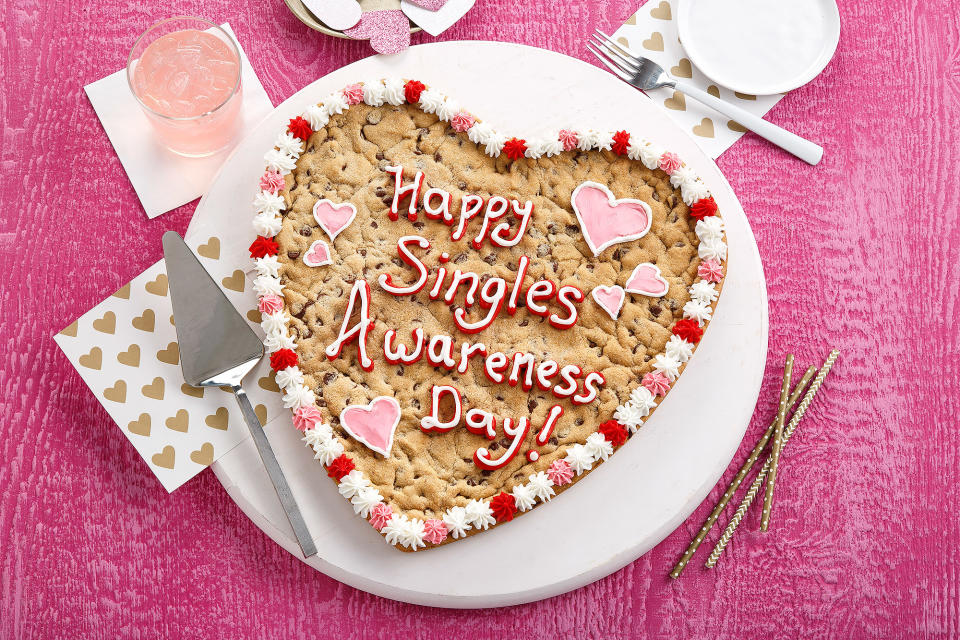 <p><a rel="nofollow noopener" href="https://www.mrsfields.com/gifts/Heart-Personalized-Cookie-Cake/#p:12;c:165" target="_blank" data-ylk="slk:This cookie cake;elm:context_link;itc:0;sec:content-canvas" class="link ">This cookie cake</a> will shine at your singles party with a fun custom message. </p>