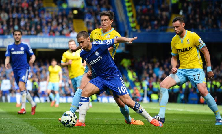 Chelsea's Eden Hazard (C) holds off a challenge during the Premier League match against Crystal Palace at Stamford Bridge on May 3, 2015