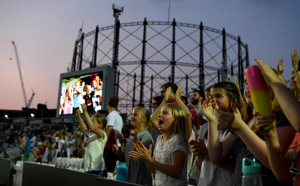 Cricket fans cheer during The Hundred match between Oval Invincibles and Manchester Originals at The Kia Oval on July 21, 2021 in London, England.