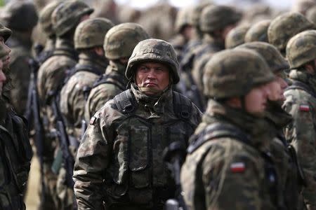 Polish soldiers attend welcoming ceremony for U.S.-led NATO troops at polygon near Orzysz, Poland, April 13, 2017. REUTERS/Kacper Pempel