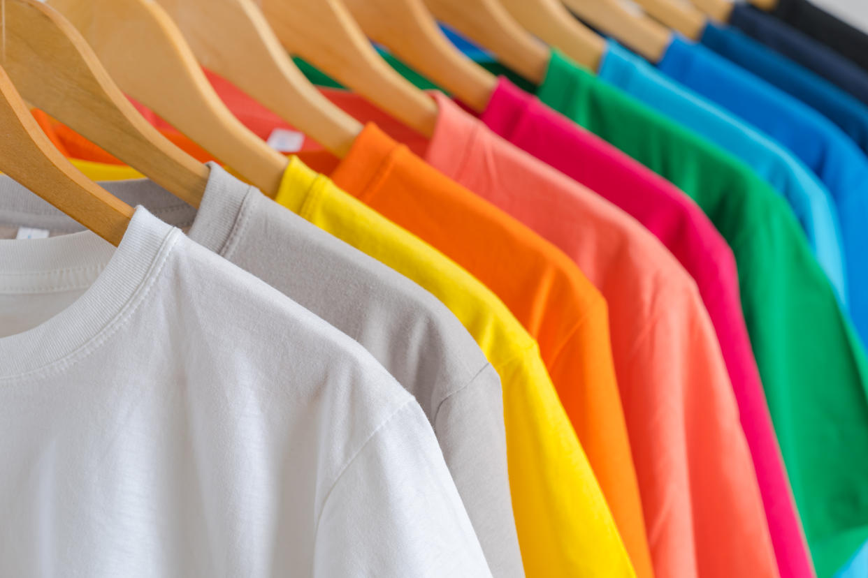 Close up of Colorful t-shirts on hangers, apparel background