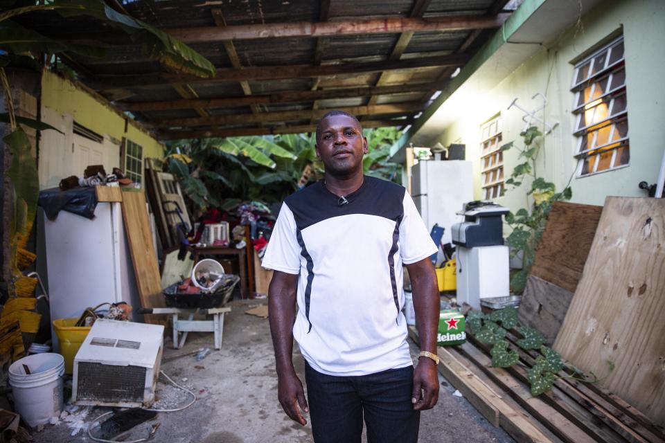 A more optimistic Medina-Dishmey stands in his driveway almost a year after Maria. He's still hoping that some kind of aid will help him to finish fixing up his home. (Photo: Carolina Moreno/HuffPost)