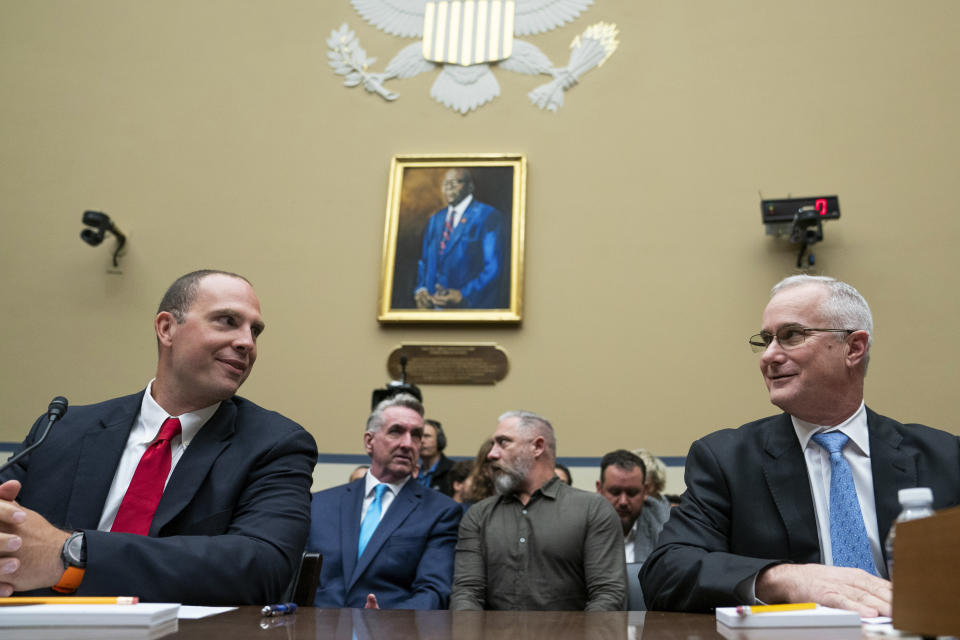 U.S. Air Force (Ret.) Maj. David Grusch, left, and U.S. Navy (Ret.) Cmdr. David Fravor, speak prior to a House Oversight and Accountability subcommittee hearing on UFOs, Wednesday, July 26, 2023, on Capitol Hill in Washington. (AP Photo/Nathan Howard)