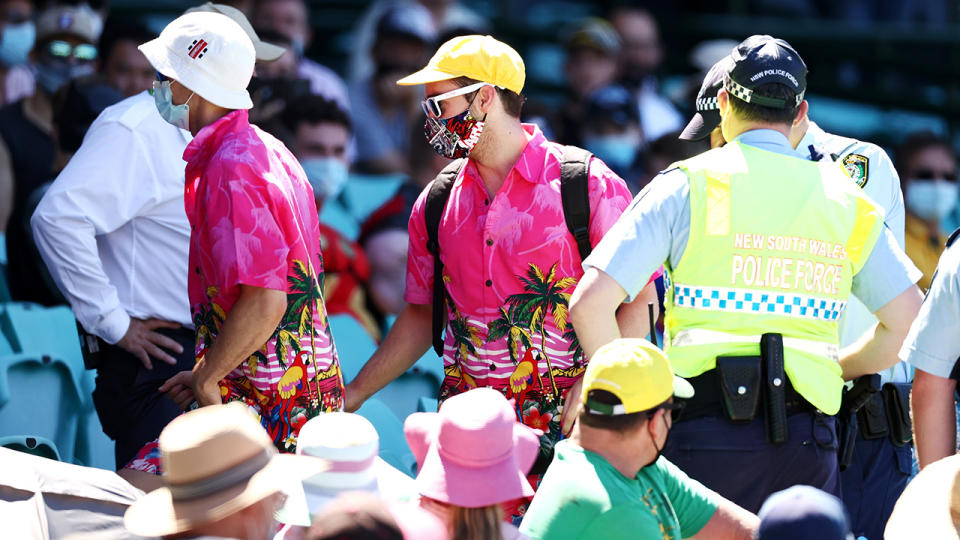 Police speak to spectators following a complaint from Mohammed Siraj of India that stopped play during day four of the Third Test match in the series between Australia and India at the SCG. (Photo by Cameron Spencer/Getty Images)