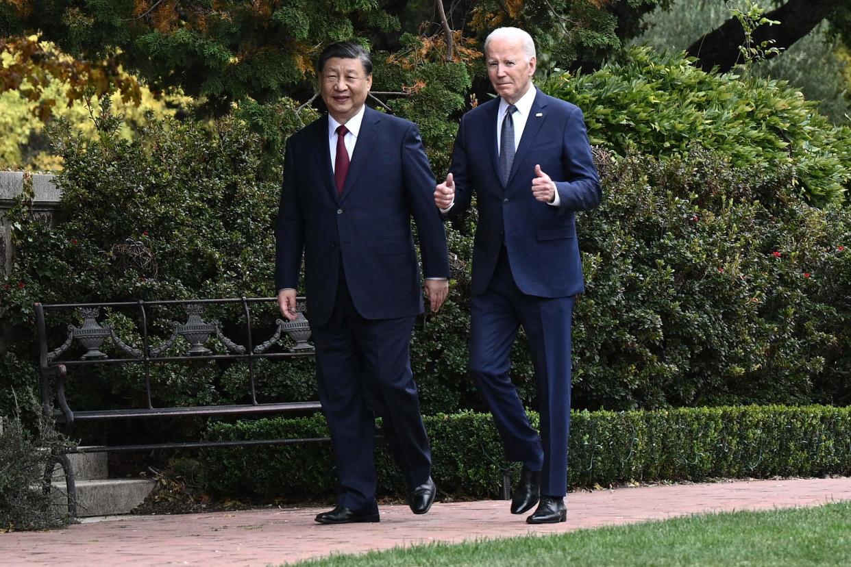 U.S. President Joe Biden (R) and Chinese President Xi Jinping walk together after a meeting during the Asia-Pacific Economic Cooperation (APEC) Leaders' week in Woodside, California on November 15, 2023.