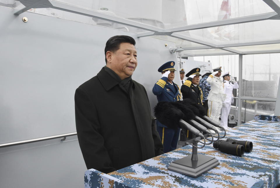 Chinese President Xi Jinping reviews a naval parade with Chinese and foreign military ships held in commemoration of the 70th anniversary of the Chinese People's Liberation Army (PLA) Navy in the sea near Qingdao in eastern China's Shandong Province, Tuesday, April 23, 2019. (Li Gang/Xinhua via AP)