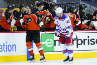 Philadelphia Flyers' Kevin Hayes, left, celebrates with teammates past New York Rangers' Brendan Smith after scoring a goal during the second period of an NHL hockey game, Wednesday, Feb. 24, 2021, in Philadelphia. (AP Photo/Matt Slocum)