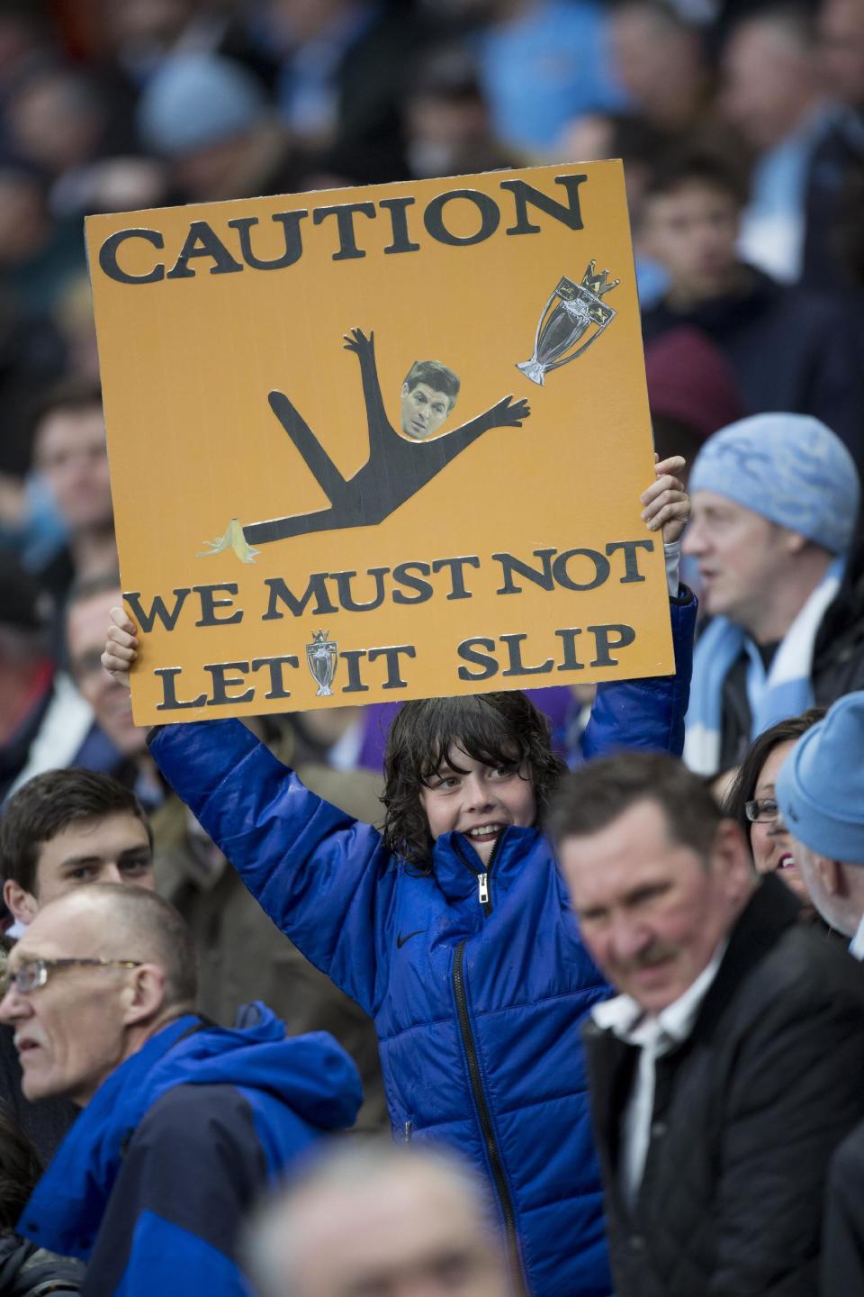 A young supporter holds up a sign before Manchester City's English Premier League soccer match against Aston Villa at the Etihad Stadium, in Manchester, England, Wednesday May 7, 2014. (AP Photo/Jon Super)