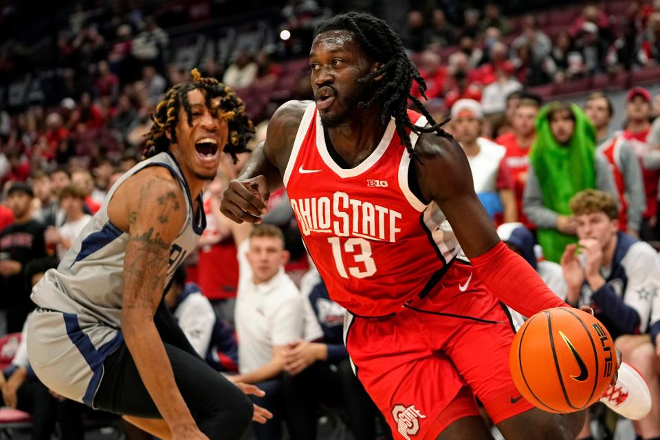 Ohio State's Isaac Likekele dribbles around Robert Morris forward Kahliel Spear.