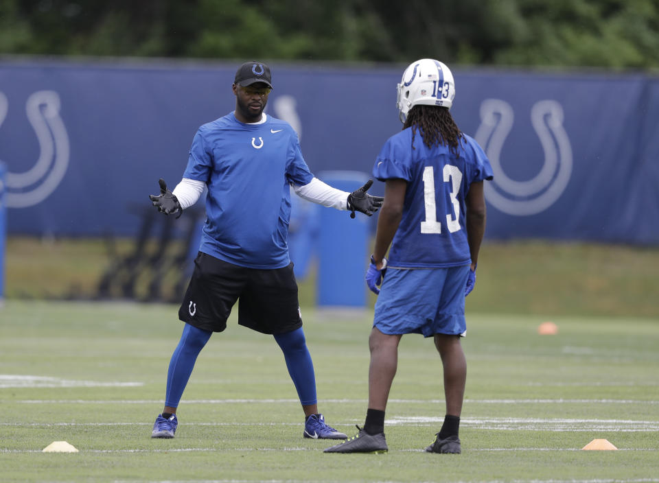 Reggie Wayne (left) isn’t walking through that door, but the Colts should get T.Y. Hilton (13) back on Sunday (AP Photo/Darron Cummings)