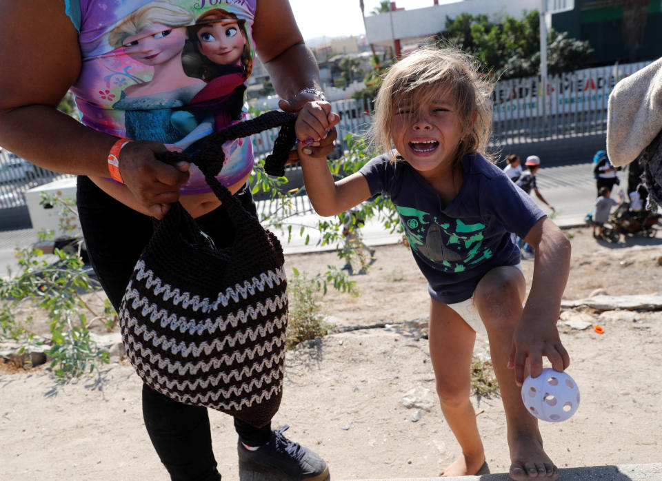 A Honduran toddler in diapers who came to the border on the migrant caravan sobs after she and her mother fled tear gas fired by American officers at the Mexican border Sunday. (Photo: Reuters)